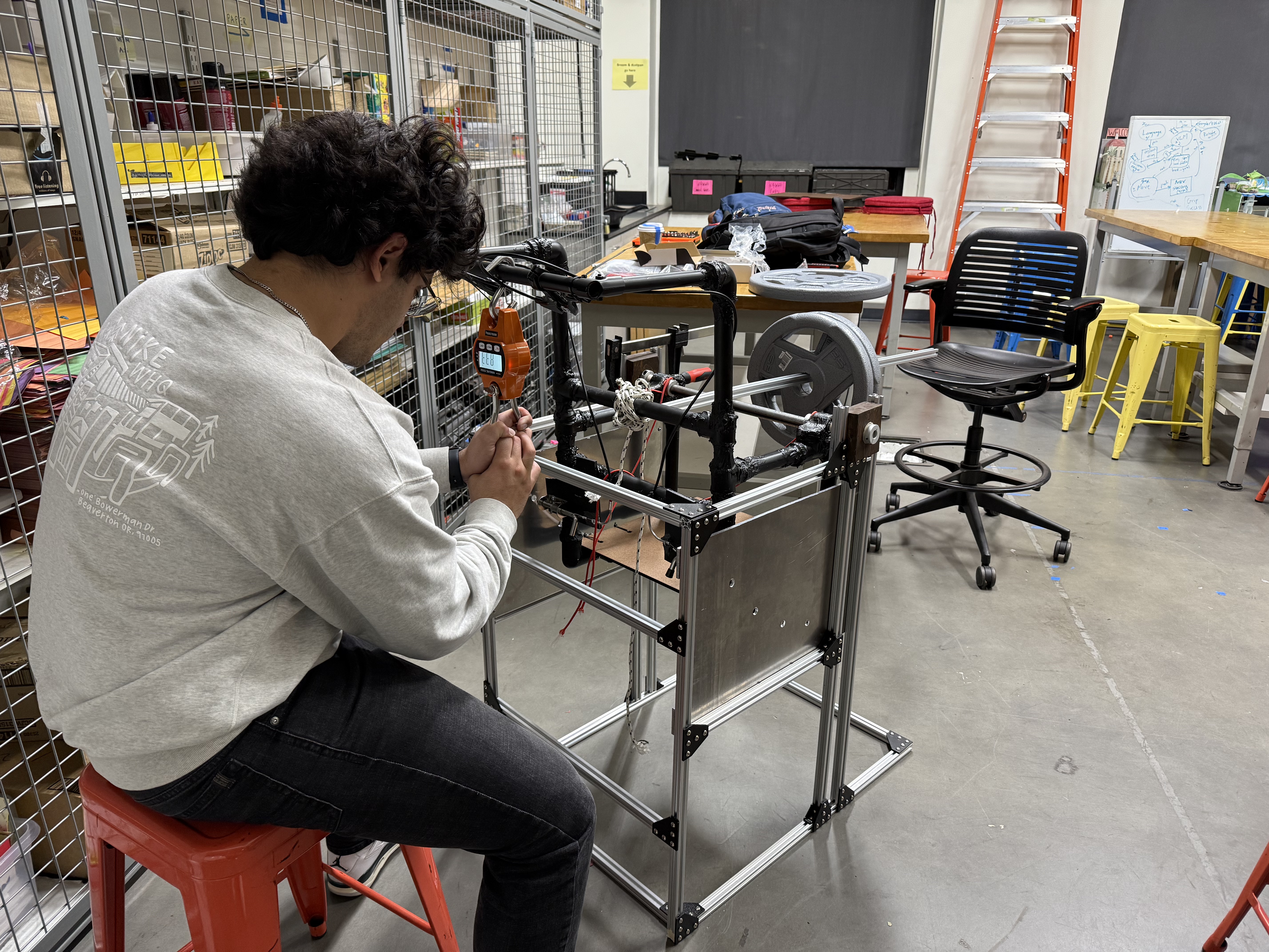 Testing leverage of the handle bar for tilt-in-space wheelchair mechanism